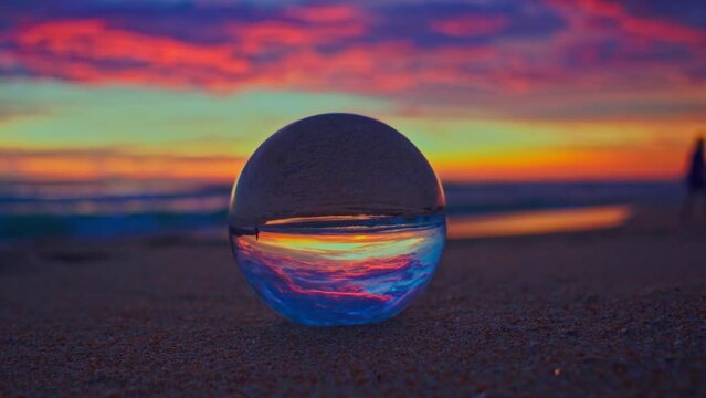 Amazing View of colorful sky at sunset inside crystal balls..beautiful cloud in sky over sea in a crystal ball on the beach. .Nature High quality footage in nature and travel concept..
