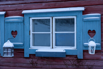 Window with heart in shutters and lantern with snow, around Muonio in the north of Finland above...