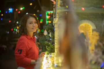 Obraz premium Thoughtful young woman against gray background,Rear view of woman standing against white wall,Beautiful young woman against wall