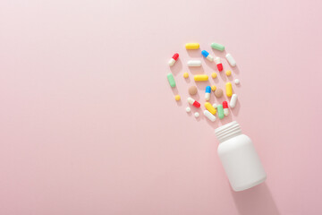 Tablets and vials on a pink background