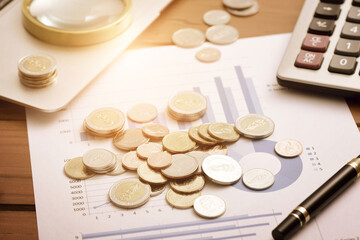 Coins, pens, and calculators placed in financial data report analysis scenarios