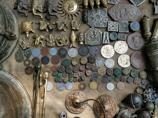 display of various coins, pendents and decorative pieces on a table