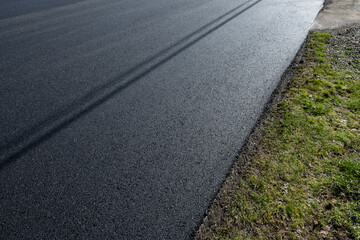 Freshly repaved asphalt road, closeup detail as a background
