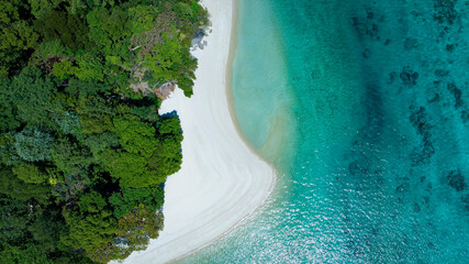 The aerial view of white sand beach tropical with seashore as the island in a coral reef ,blue and...