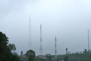 communication towers on a misty mountain