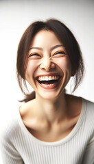 笑顔(爆笑)のアジア人(日本人)女性　Portrait of a Beautiful Asian Woman with her Smooth skin looks at the camera on a White background in Studio light.