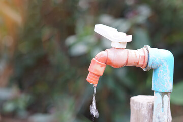 Old water faucet with dripping. Concept. Save water for environment. Turn off tap or faucet  before...