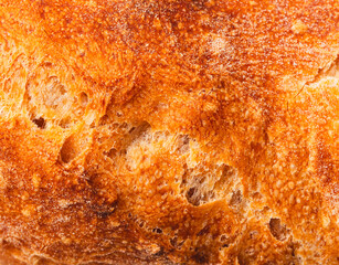Ruddy crust of bread as an abstract background. Texture