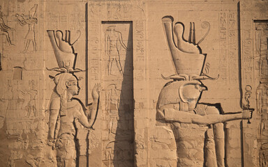Ancient egyptian carvings and hieroglyphs at the temple of Horus in Edfu, Aswan, Egypt  - obrazy, fototapety, plakaty