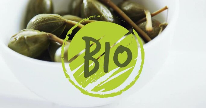 Animation of bio text over capers in bowl on table