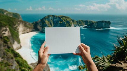 hand holding a blank sheet of paper, with the background of nusa penida beach bali, Ai Generated Images