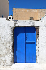 Greece: Blue door and lime-washed walls. Details of the beautiful traditional architecture.