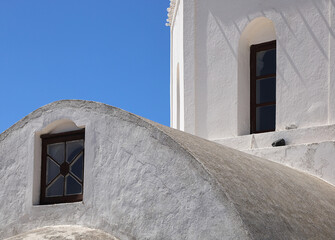 Greek traditional architectural detail, lime-washed walls against a blue sky