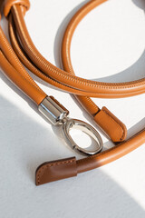 Genuine leather bag strap or handbag handle in brown color isolated on white background