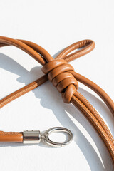 Genuine leather bag strap or handbag handle in brown color isolated on white background