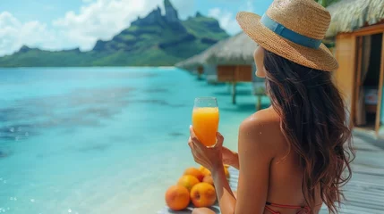 Photo sur Plexiglas Bora Bora, Polynésie française Breakfast at luxury hotel room on beach. Asian woman drinking fruit juice morning on summer vacation travel in Bora Bora island, 