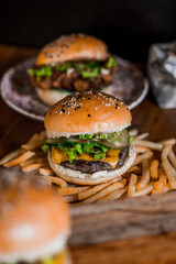 Top-down view of two cheeseburger with a toasted sesame seed bun and a medium-rare beef patty