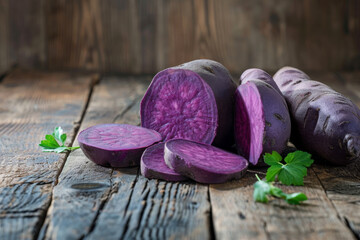 Purple potatoes on a wooden background.
