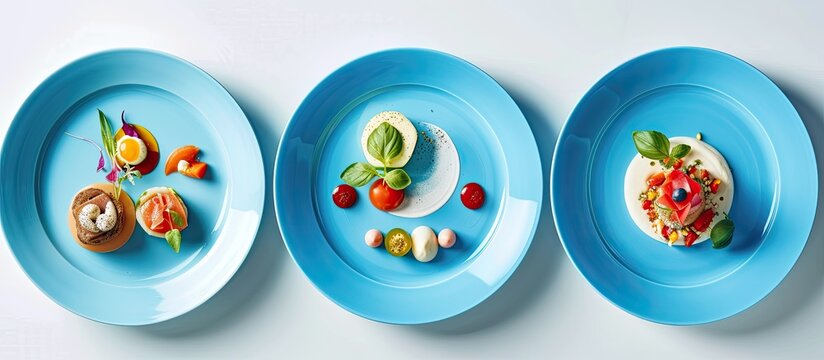 A trio of mouthwatering courses served on blue plates over a crisp white background. The plates each hold a unique dish, showcasing a variety of colors and textures.