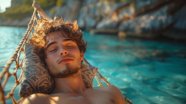 Close-up Of A Young Man Sleeping On Hammock In Front Of Idyllic Sea At Beach