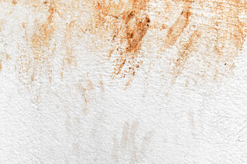 Dirty white painted stucco concrete wall with red soil and mud stains. Uneven render cement wall...