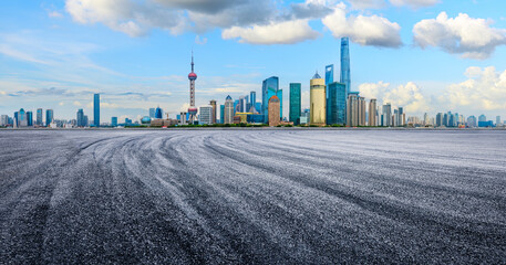 Empty asphalt road and modern commercial buildings background