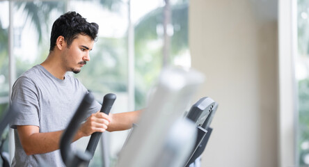 Focused individual using a cardio machine, demonstrating the dedication and intensity that goes...