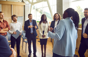 Team of business people discuss problems in work meeting. Diverse African American and white...