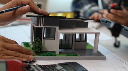 Closeup of hands engineer and architect team discussed about construction and architectural drawings works.