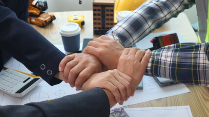 Closeup of hands engineer and architect team discussed about construction and architectural drawings works.