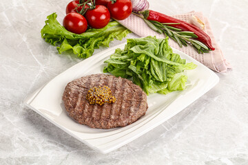 Frilled beef burger cutlet with iceberg