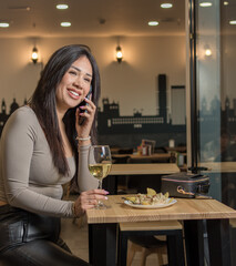 Smile, happy and coffee shop young woman enjoying a glass of wine in a restaurant or cafe on her lunch break. Portrait of happy customer drinking wine with happiness