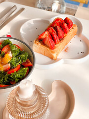Peanut butter and Strawberry toast with kale and tomato salad for breakfast.Morning time.Fresh meal. Delicious food.Homemade food. Cooking recipes. Brunch.Healthy recipes. Kids menu. Toast combination
