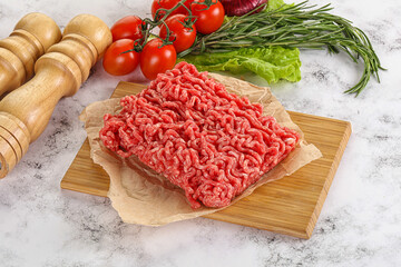 Raw minced beef meat on cutting board