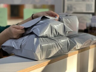 Packing a parcel for shipment. Poly Mailer Bag.