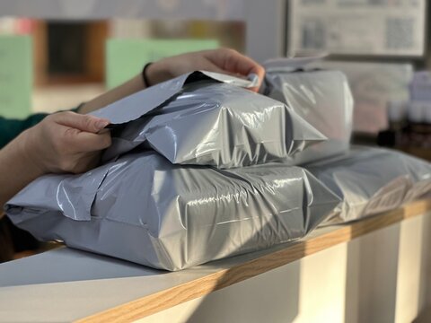Packing a parcel for shipment. Poly Mailer Bag.