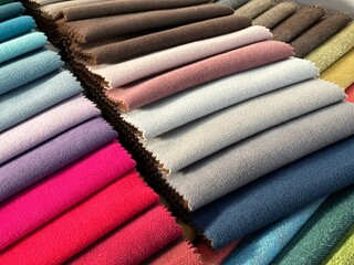 Colorful and bright fabric samples of furniture and clothing upholstery. Close-up of a palette of...