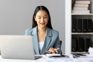 Asian businesswoman secretary doing paperwork on desk in office.