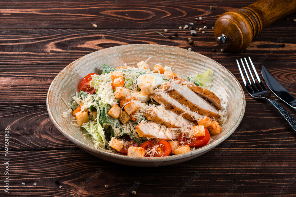 Canvas Prints italian food caesar salad with chicken, parmesan cheese, lettuce, eggs, tomatoes, croutons on a wood