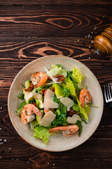 Fresh salad of shrimp, avocado, sun-dried tomatoes, parmesan cheese, lettuce and arugula.