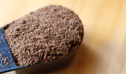 Close-up of ground coffee in a scoop