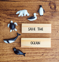 Save the oceans text on wooden blocks with sea animals 
