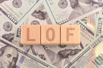 There are blocks with LOF letters printed on the US dollar props