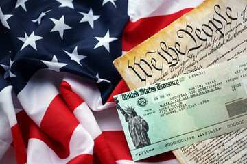 Preamble to the Constitution of the United States and refund check on American Flag. Old yellow...