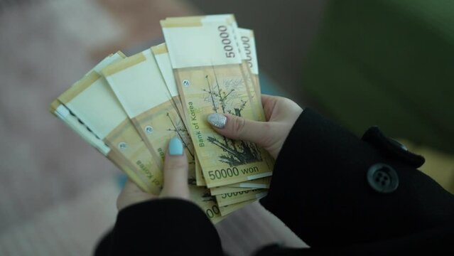 Counting South Korean 50,000 Won Banknotes