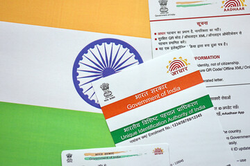 Indian Aadhaar card from Unique Identification Authority of India on Indian flag close up