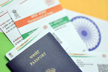 Indian Aadhaar card from Unique Identification Authority of India and Passport on Indian flag close...