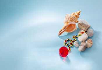 modern jjewellery with stones and seashell on blue background
