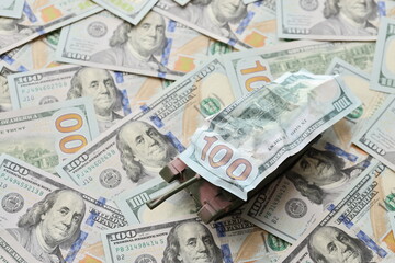 Tank on crumpled hundred dollar bills banknotes. Background of war funding and military support price for United States of America