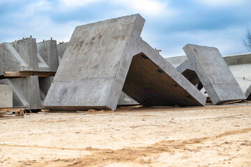 Large reinforced concrete structures at the construction site. Preparation for the installation of reinforced concrete products. Construction work on the construction of foundations.